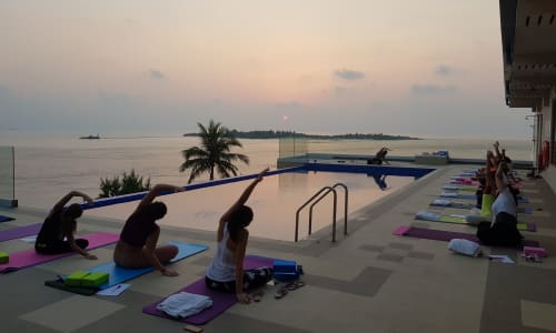 Sunrise yoga session on the beach Maldives
